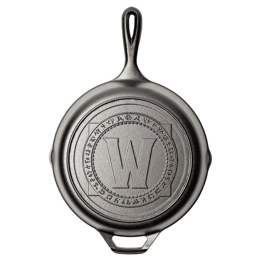 Cast iron skillet with a World of Warcraft engraved logo.