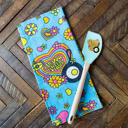 Towel and spatula on wooden counter.