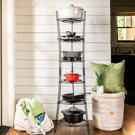Storage shelf being used in home to hold a variety of cookware including dutch ovens, skillets, baking pans, and more.