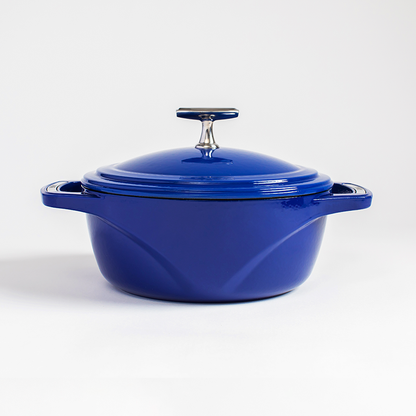 Blue enameled cast iron Dutch oven with a lid on a white background