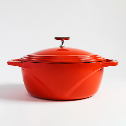 Red enameled cast iron Dutch oven with a lid on a white background