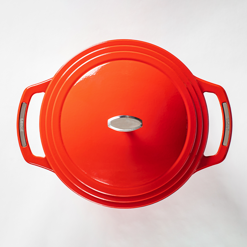 Top of red dutch oven lid with silver lid knob and silver accents on handles.