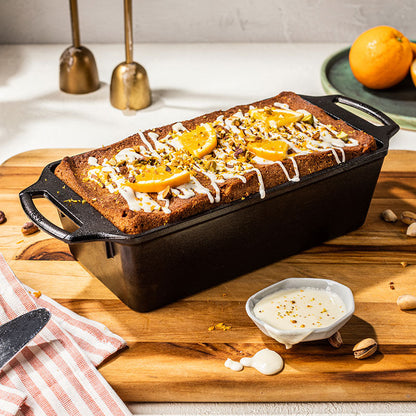 Freshly baked orange pistachio loaf drizzles with frosting.