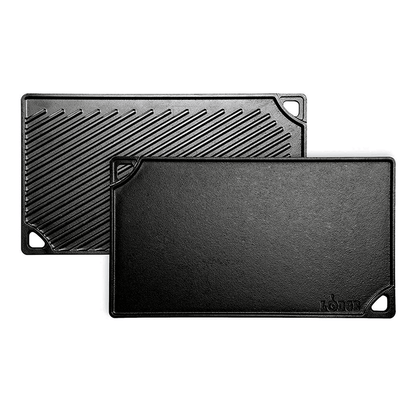 Two black reversible grill/griddle pans, one with a ribbed surface and the other with a smooth surface, both with handles.