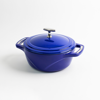 Blue enameled cast iron Dutch oven with a lid on a white background