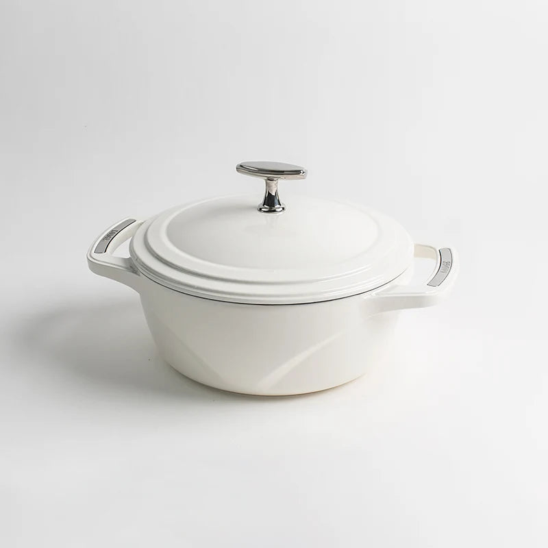 White enameled cast iron Dutch oven with a lid on a white background