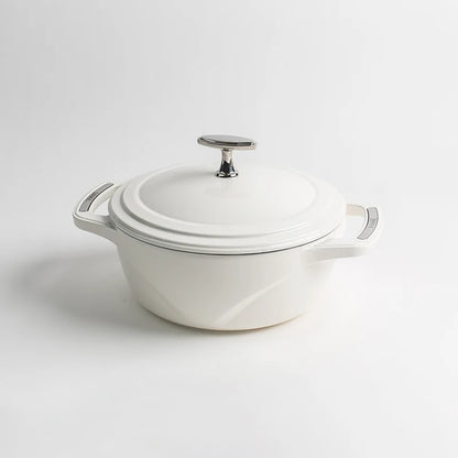 White enameled cast iron Dutch oven with a lid on a white background