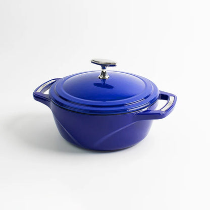 Blue enameled cast iron Dutch oven with a lid on a white background