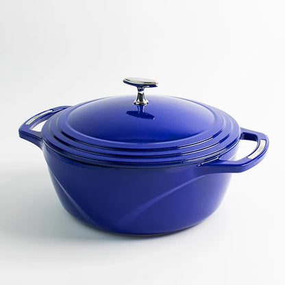 Blue enameled cast iron Dutch oven with a lid on a white background