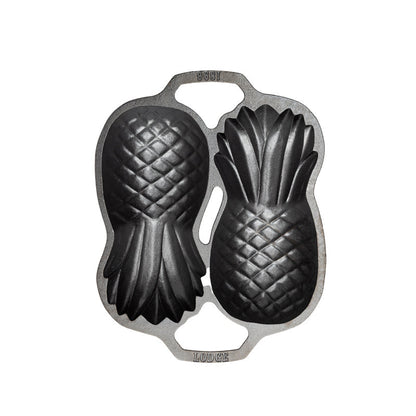 Top view of cast iron pan with 2 Pineapple-shaped molds.