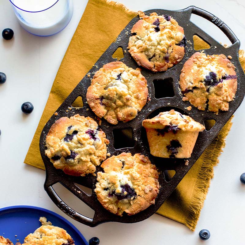 Freshly made blueberry muffins, prepared and served in pan.
