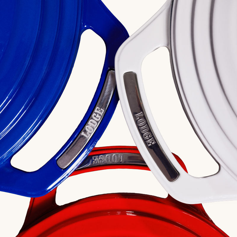 Red, white, and blue dutch ovens with handles overlapping.