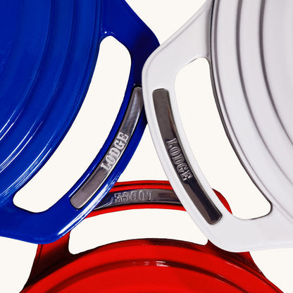 Red, white, and blue dutch ovens with handles overlapping.