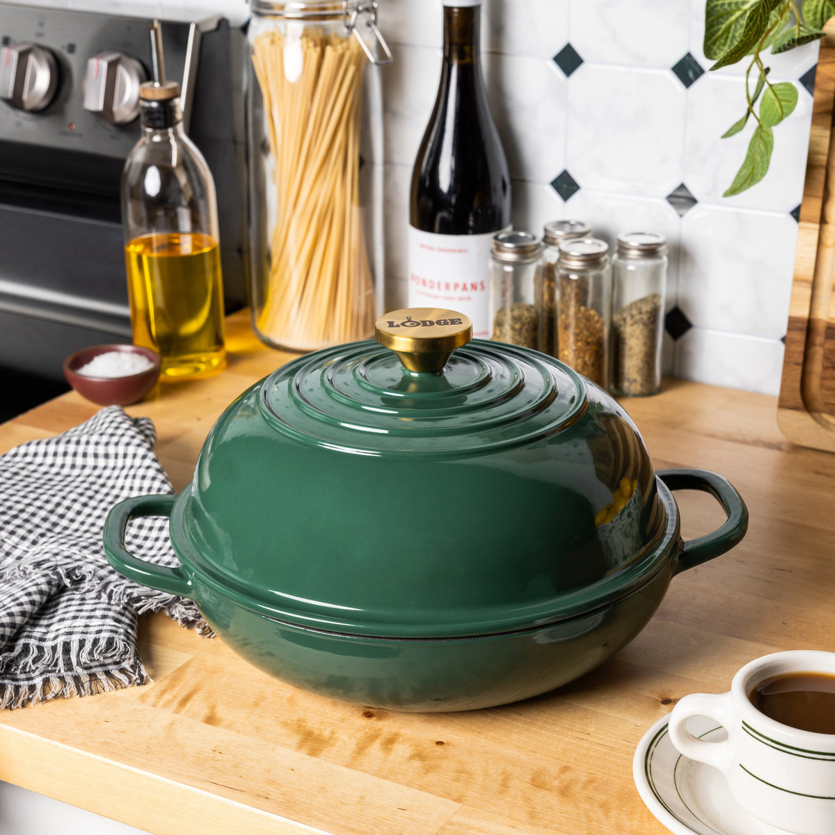 Emerald colored bread oven with a gold knob on kitchen counter.