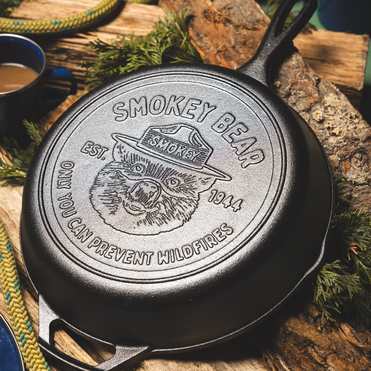 Close-up of Smokey Bear skillet, logo includes slogan "Only you can prevent wildfires".