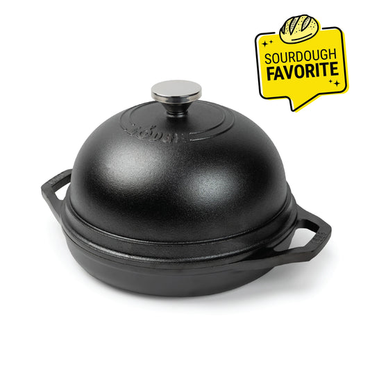 Black bread oven with 2 side handles on base and a silver knob on lid. Image features a "Sourdough Favorite" badge.