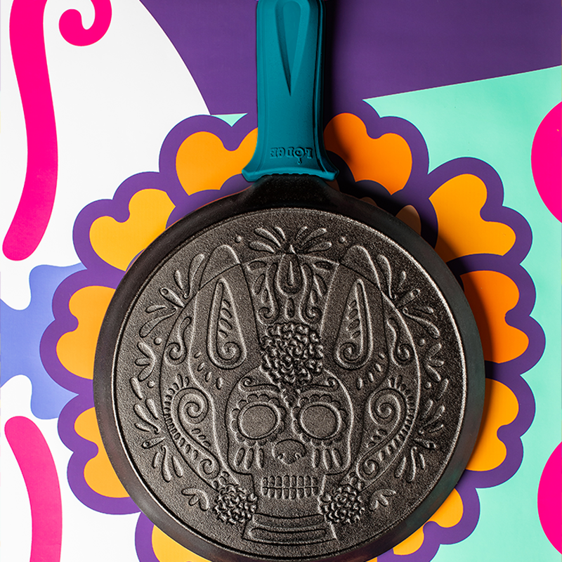 Griddle laying flat on colorful background.