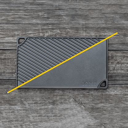 Griddle/grill pan on wood surface with handles on opposite corners.