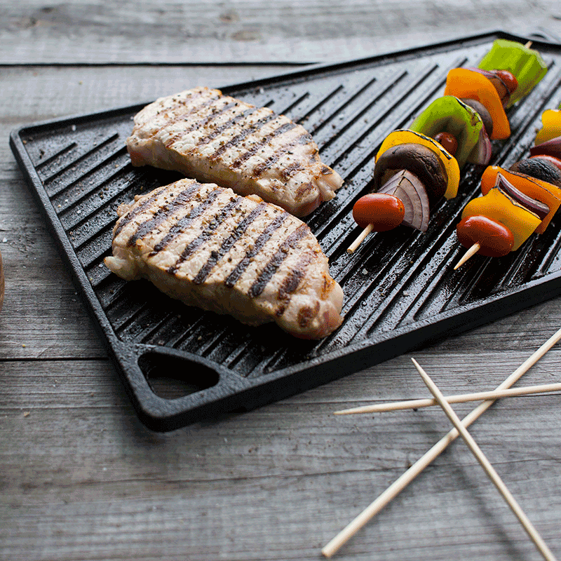 Grilled meat and vegetable skewers on a cast iron grill pan.