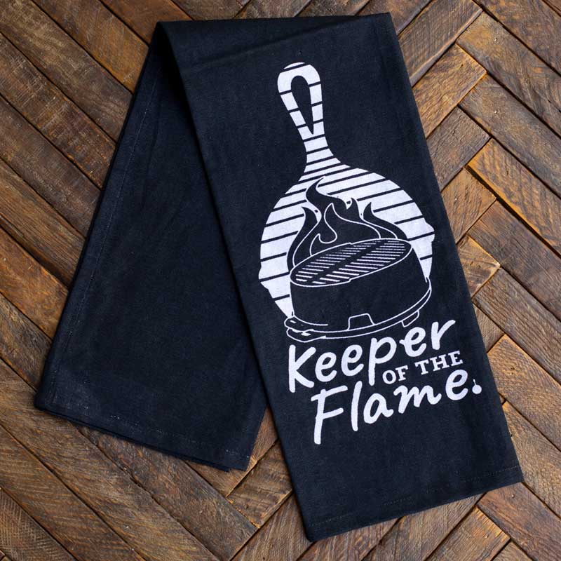 Towel on counter, partially unfolded to show plain black design.