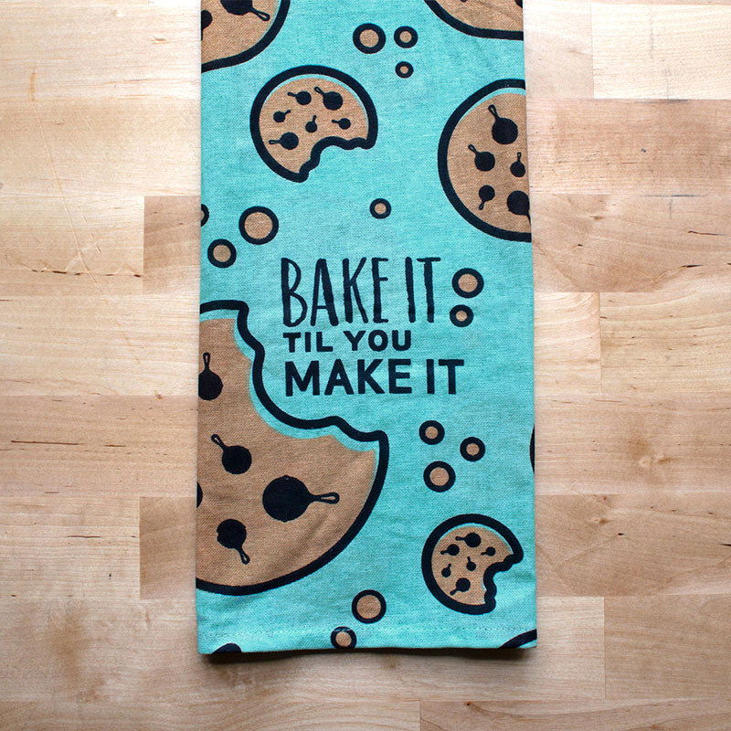 Closeup of towel showing chocolate chip details on cookie being shaped like a skillet.
