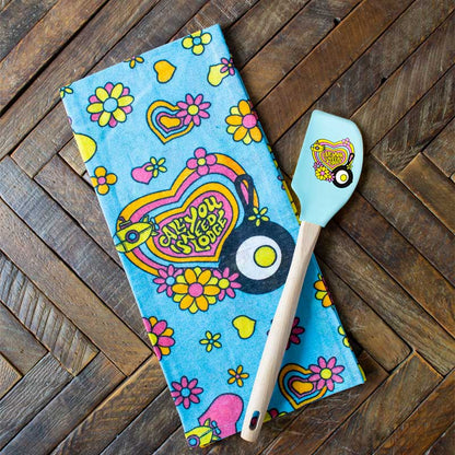 Towel and spatula on wooden counter.
