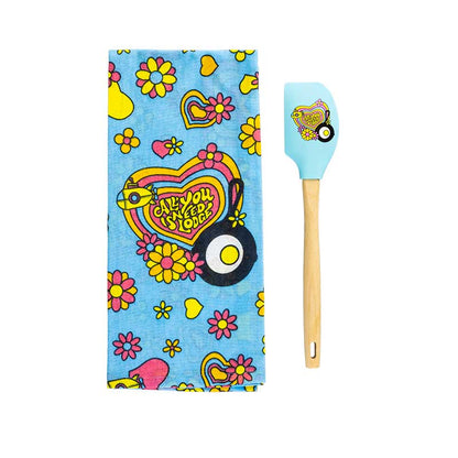 Colorful kitchen towel with heart and flower design and matching spatula on a white background