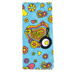 Colorful towel with floral patterns and a heart-shaped logo with text "All You Need Is Lodge" next to the Lodge skillet and egg logo on a blue background.