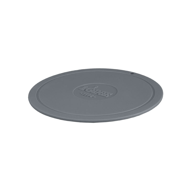 Grey circular trivet with Lodge branding in center.