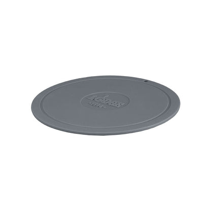 Grey circular trivet with Lodge branding in center.