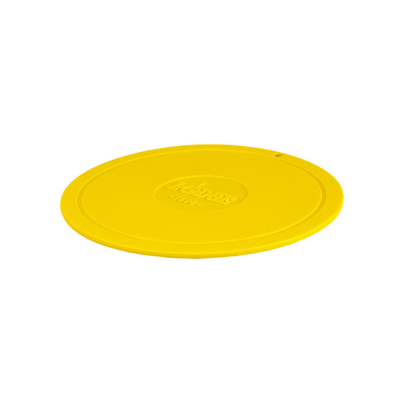 Yellow circular trivet with Lodge branding in center.