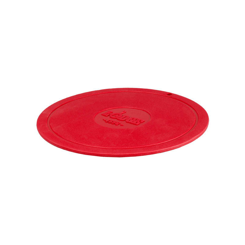 Red circular trivet with Lodge branding in center.