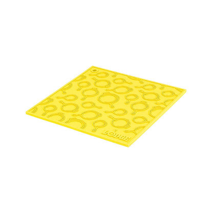 Yellow silicone trivet with embossed Lodge skillets scattered throughout surface.