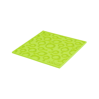 Green silicone trivet with embossed Lodge skillets scattered throughout surface.