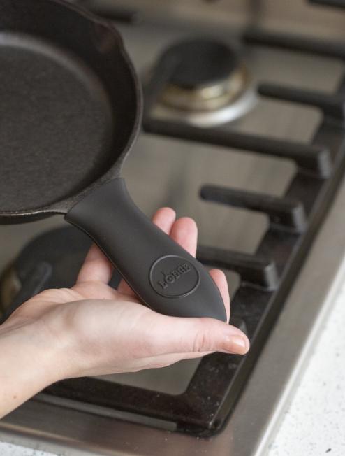 Someone holding skillet with handle holder.