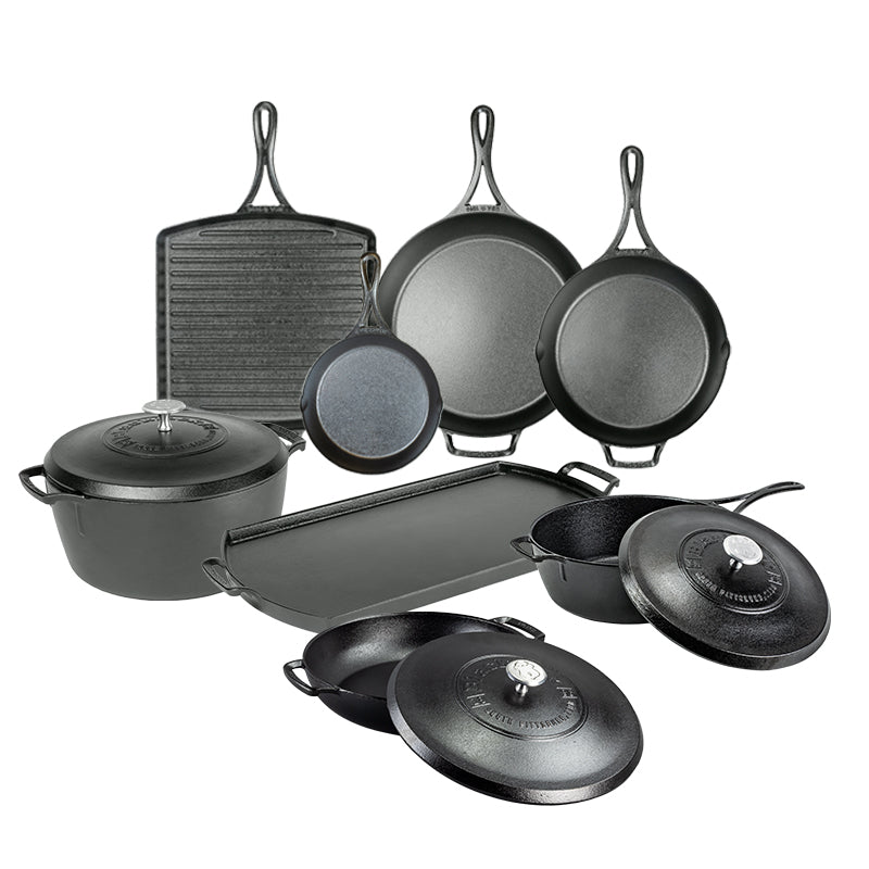 Set of black cast iron cookware including skillets, pans, and a dutch oven on a white background