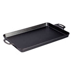 Black cast iron, rectangular pan with handles and shallow edges.