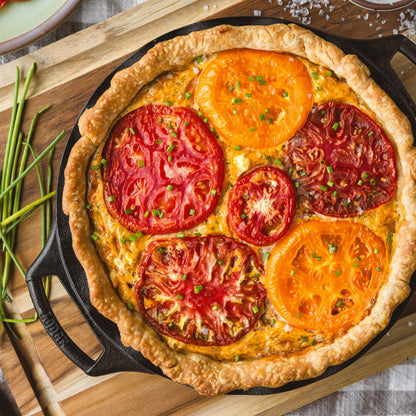 Southern tomato pie baked in seasoned cast iron pie pan.
