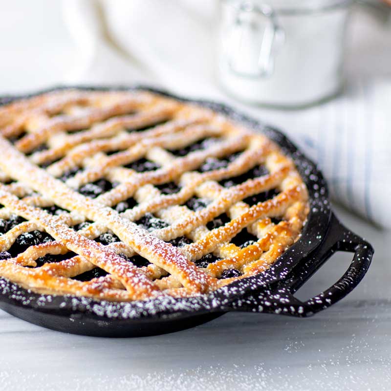 Freshly baked blue berry pie with powdered sugar.