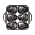 Mini cake pan with 6 skull shaped cups.