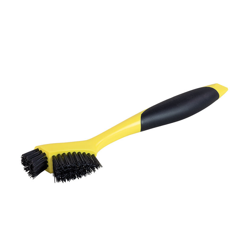 Yellow brush with black handle and 2 sets of black bristles, one in line with the handle the other sticking out of the top.
