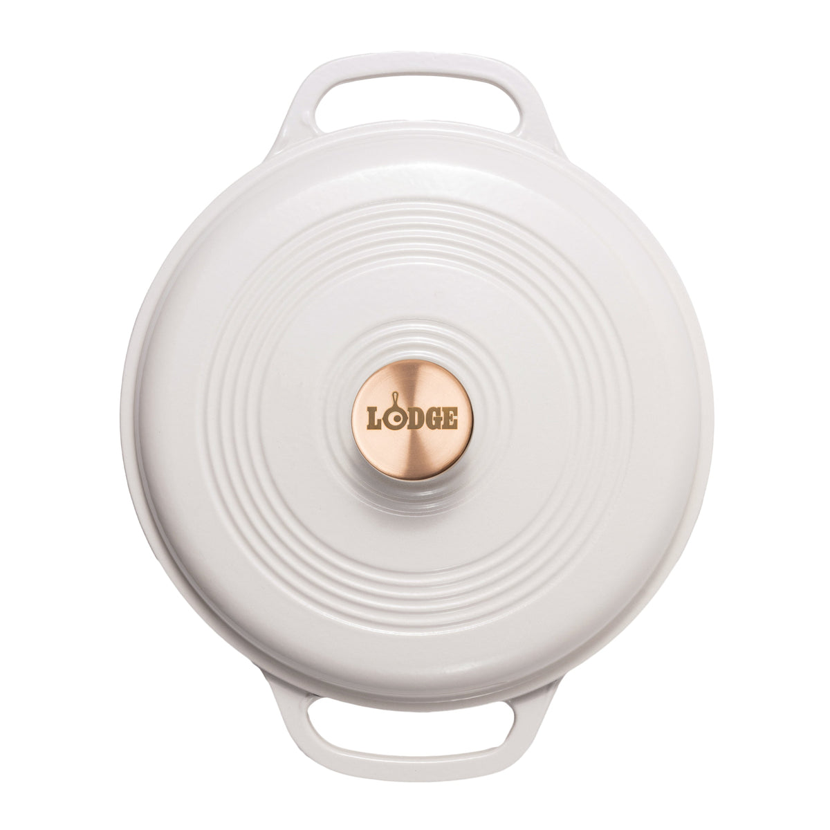 A top-down view of a white Lodge round cast iron Dutch oven lid with two handles and a copper center knob.