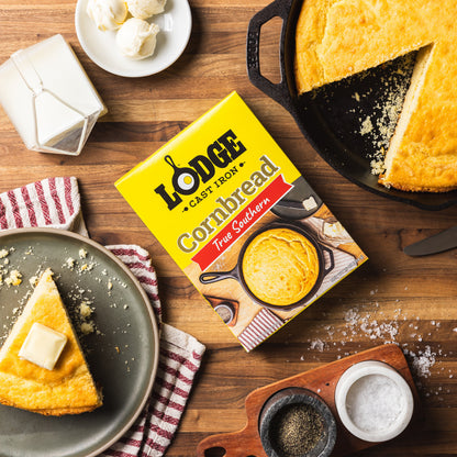 Lodge cast iron cornbread mix box with cornbread on a wooden table