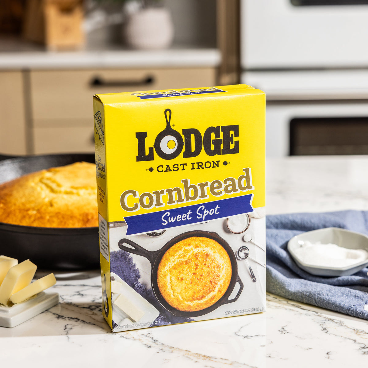 Lodge Cornbread mix box with a cornbread loaf in the background