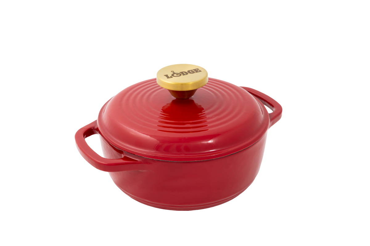 Ruby red enameled cast iron Dutch oven including a lid with gold knob.