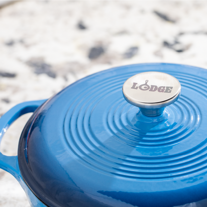 Close up of lid featuring silver knob with Lodge branding.