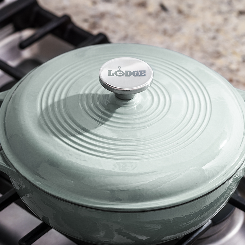 Close up of lid featuring silver knob with Lodge branding.