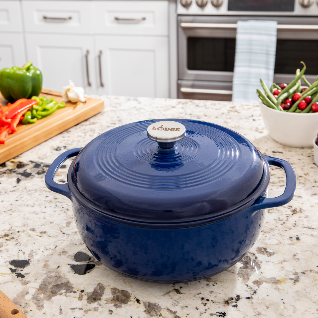 Dutch oven on kitchen counter near prepped ingredients.