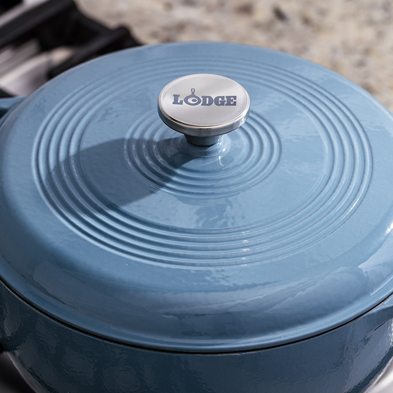 Close up of lid featuring silver knob with Lodge branding.