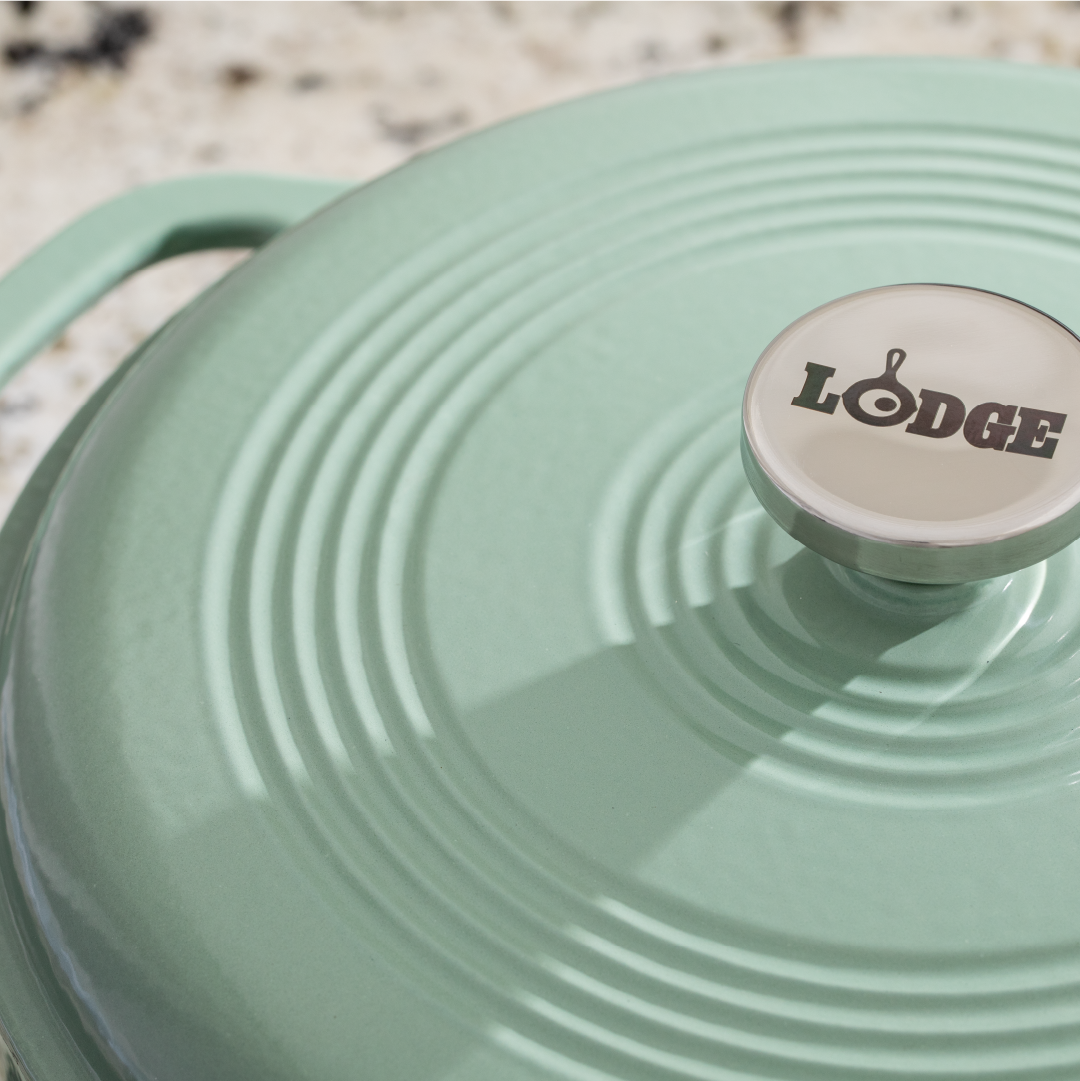 Close up of lid featuring silver knob with Lodge branding.